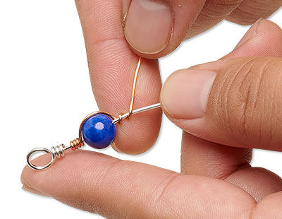 Beaded wire being wrapped with copper wire